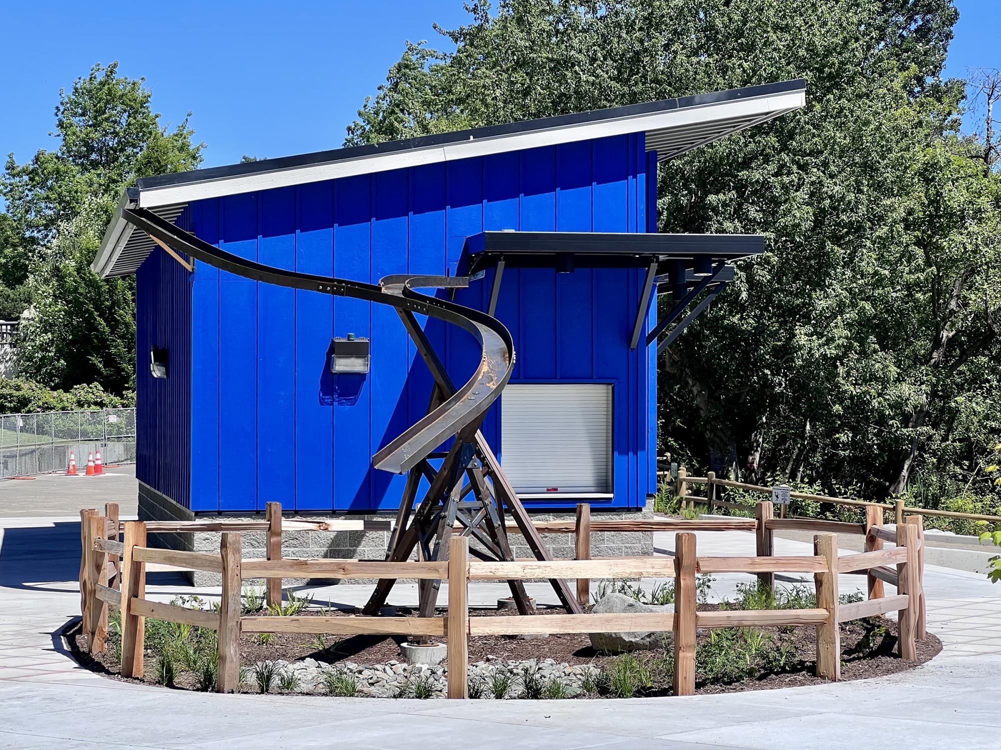 Metal wave sculpture in front of building